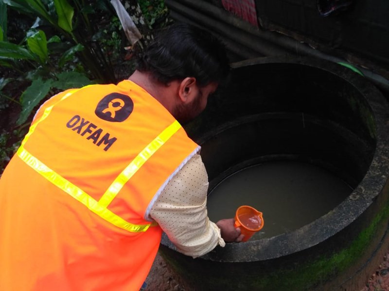 A member of Oxfam India’s humanitarian team conducting a water quality assessment using water from a well. (Photo: Oxfam India)