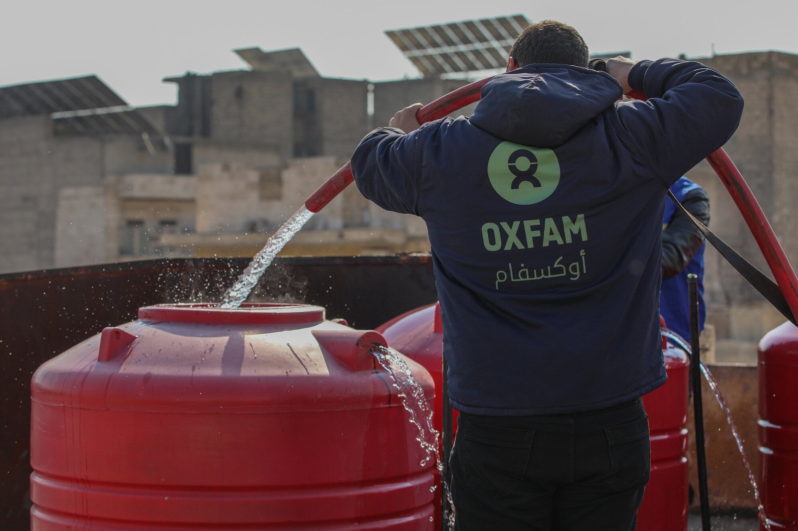 Oxfam delivering water to shelters in Aleppo city.